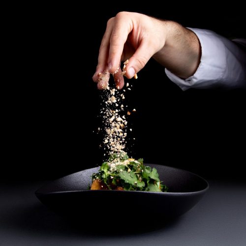 chef-sprinkles-salad-with-nuts (1)