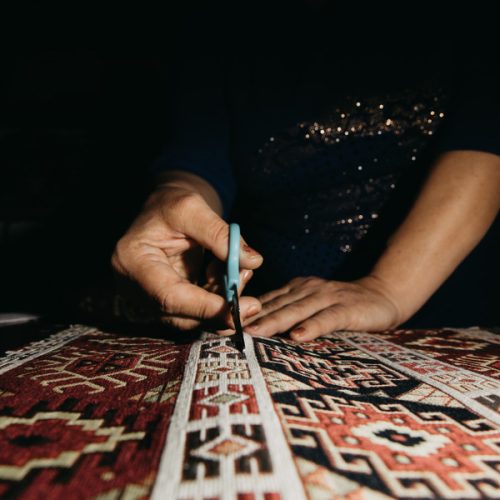 cutting-ethnic-carpet-with-scissors (1)